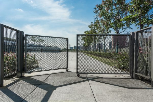 Wrought iron gate and stone pillar isolated on white background.